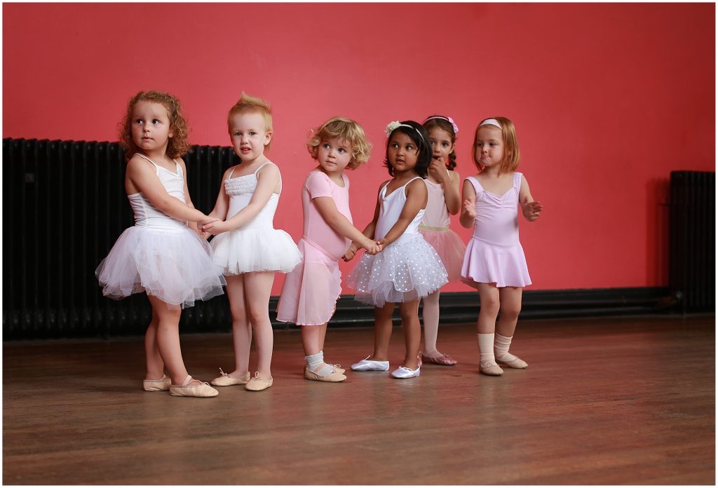 Pre-school ballerinas holding hands in class at The Village School of Dance in Wimbledon
