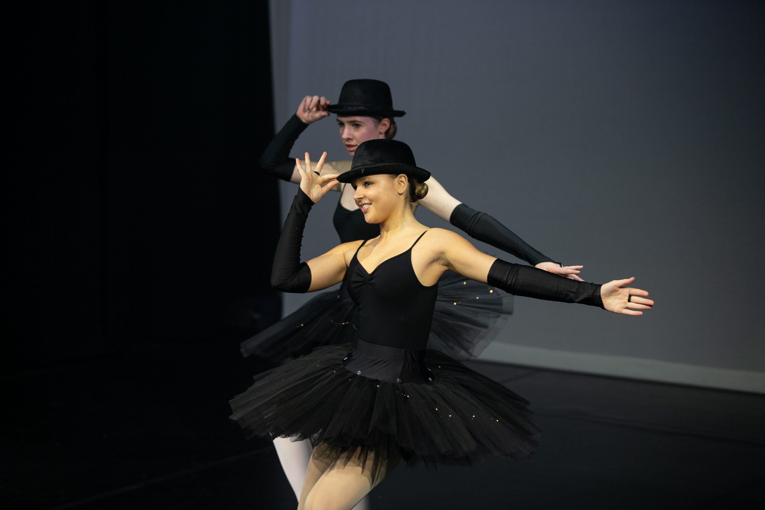 Modern duet in bowler hats performing on stage