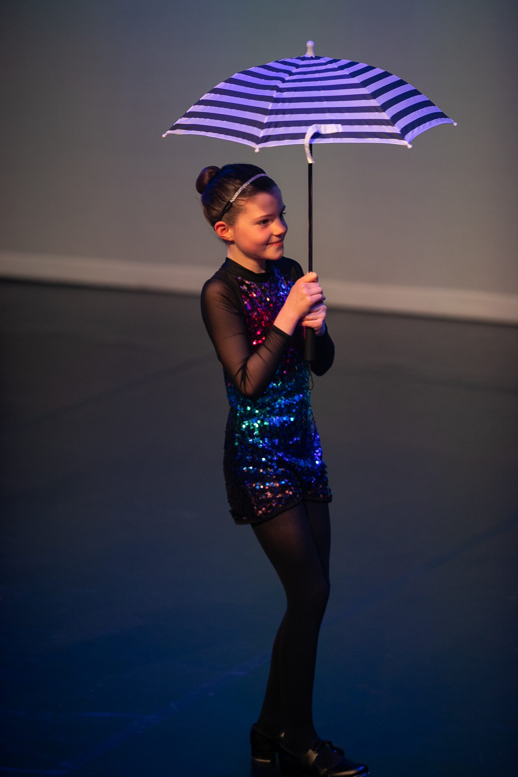 Tap soloist performing with an umbrella at the school show